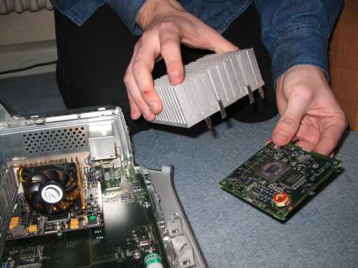 [New CPU on board, old cooler and CPU in hand, scratch on finger]